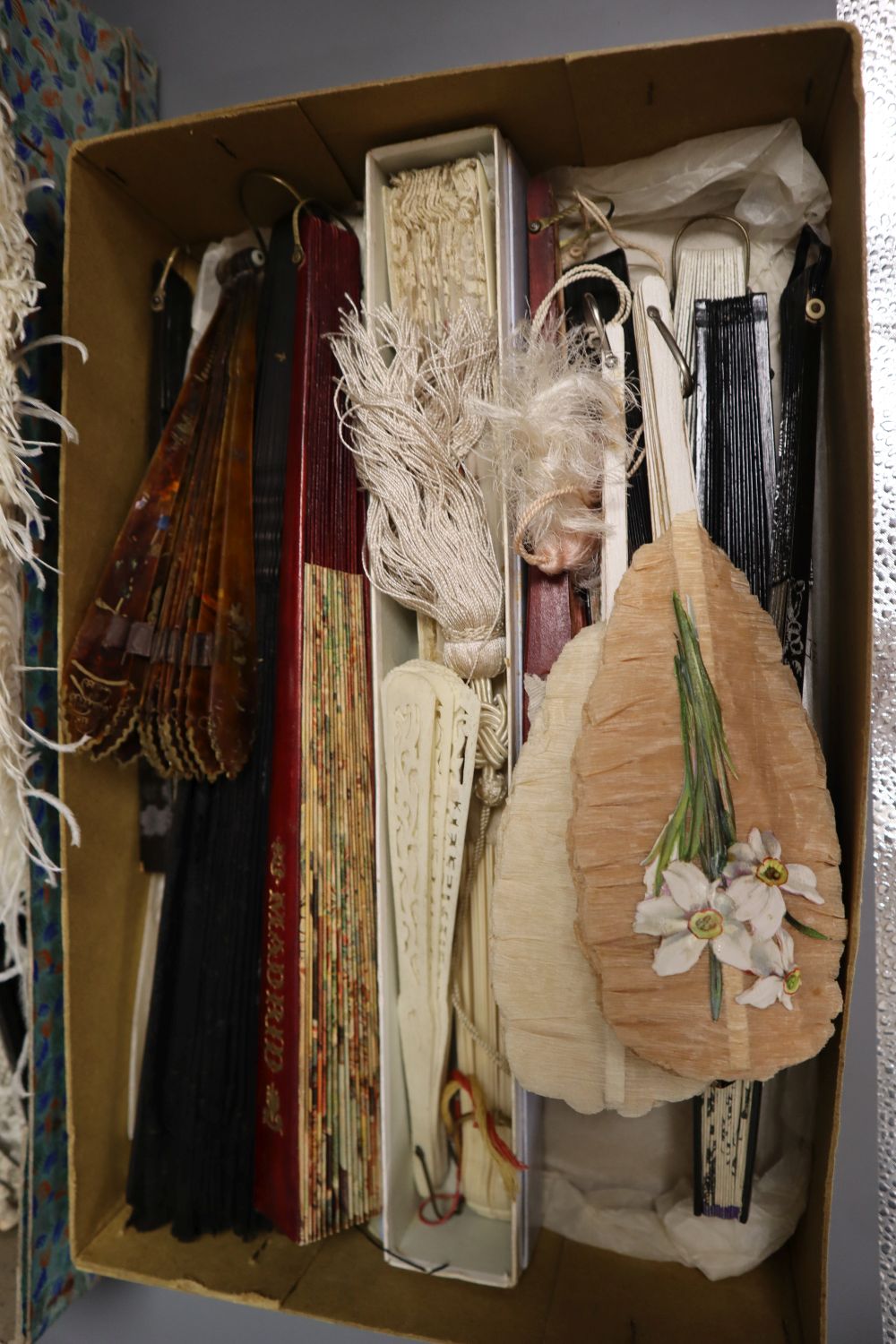 A collection of fans and a lace parasol